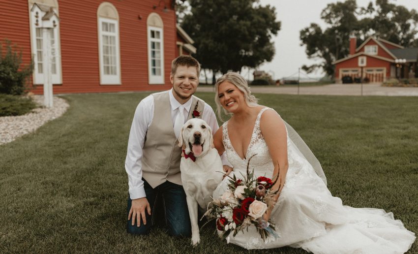 Bride and groom with dog at outdoor Minnesota wedding venue